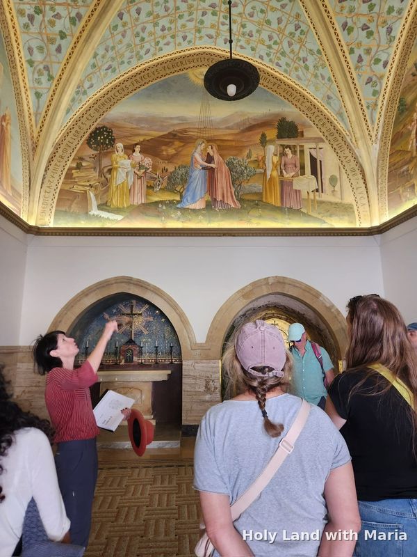 Maria Lando showing the Visitation fresco to her group in Ein Karem
