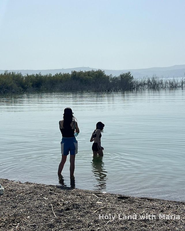 Wading in the shallow water of the Sea of Galilee