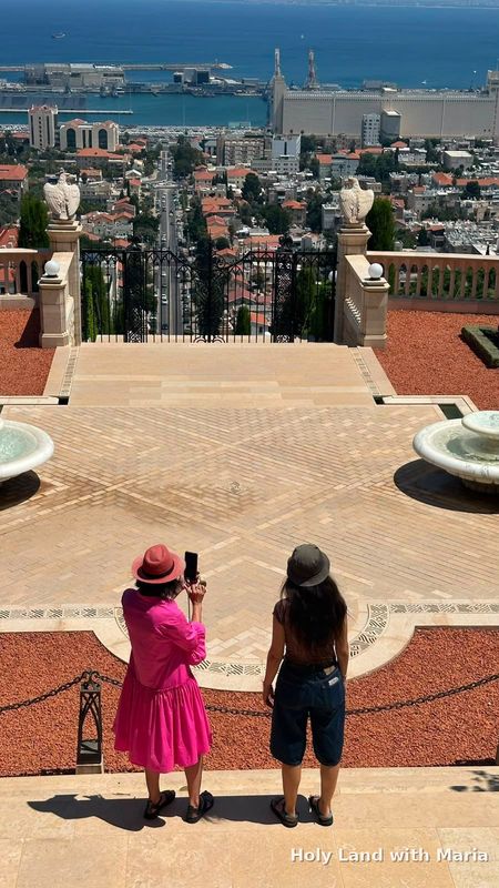 Tour guests photographing Haifa Bay from the Bahá'í Gardens terrace