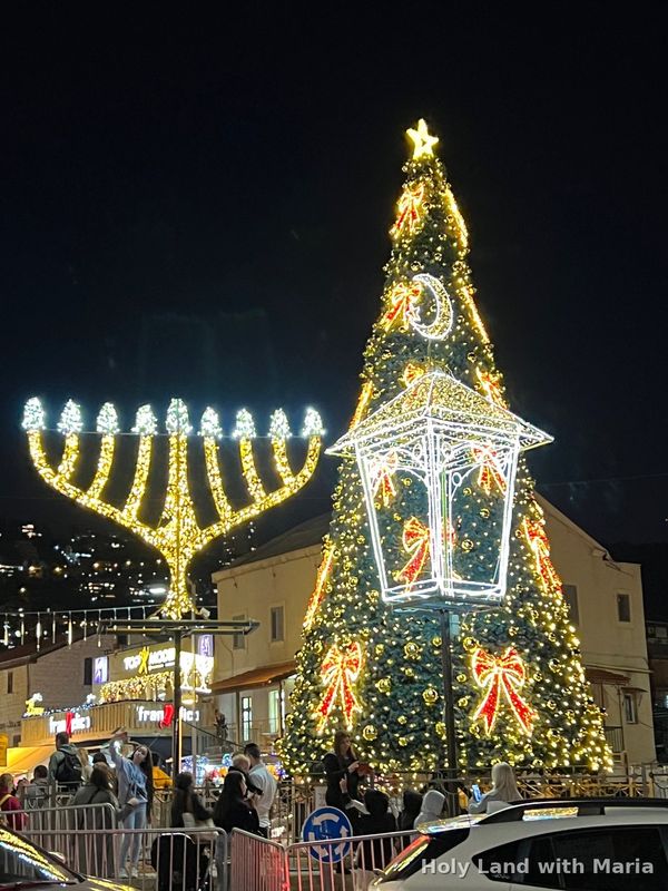 Hanukkah menorah beside a lit Christmas tree at Haifa's Holiday of Holidays festival
