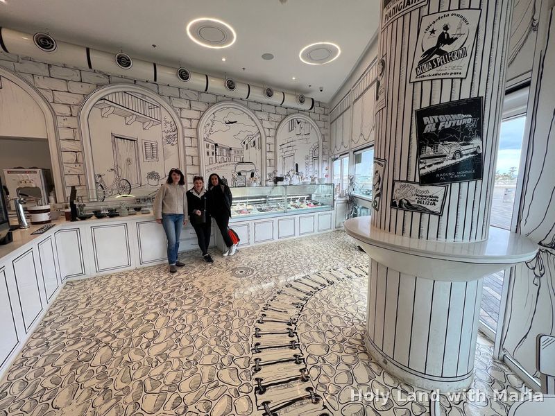 Tour guests inside Sketch Cafe, the hand-drawn black-and-white café in Haifa