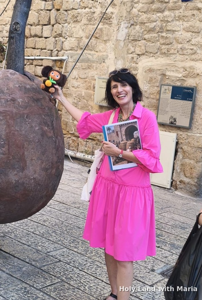 Maria Lando beside a giant clay storage jar in Old Jaffa