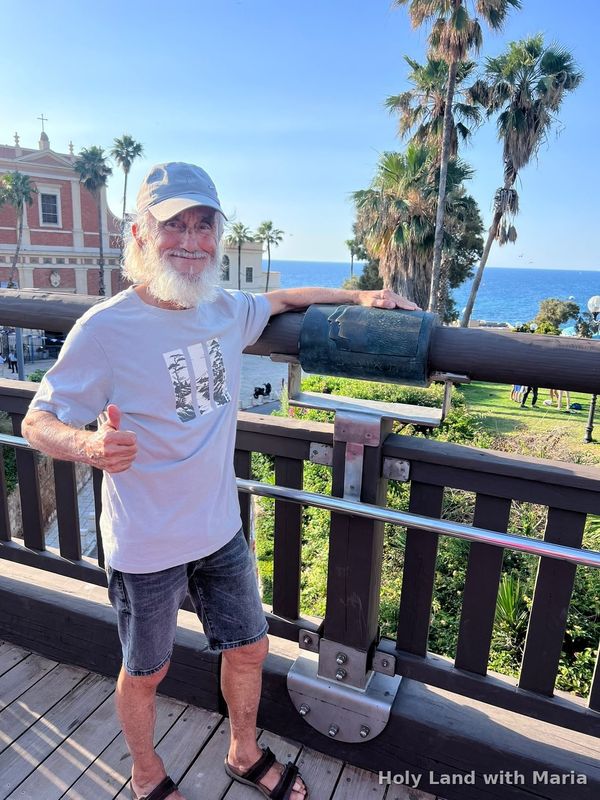 A guest on the Jaffa tour at the railing above the sea